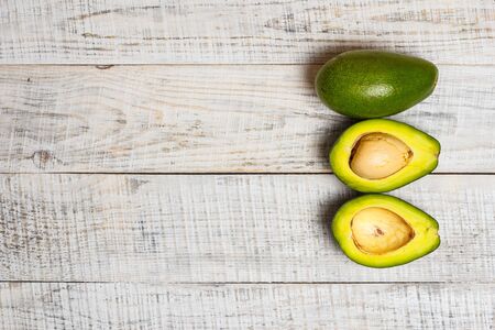 Sliced green avocado on a white surface in provence styleの写真素材