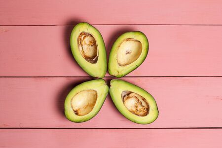 Sliced green avocado on a red beautiful surface