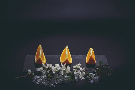 Sweet ripe orange on a black surface and black backgroundの写真素材