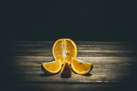 Ripe and tasty orange on a brown wooden surfaceの写真素材