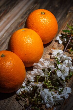 Ripe and tasty orange on a brown wooden surfaceの写真素材