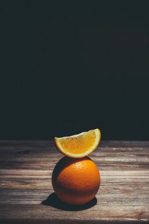 Ripe and tasty orange on a brown wooden surfaceの写真素材