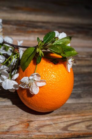 Ripe and tasty orange on a brown wooden surfaceの写真素材