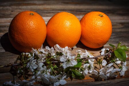 Ripe and tasty orange on a brown wooden surfaceの写真素材