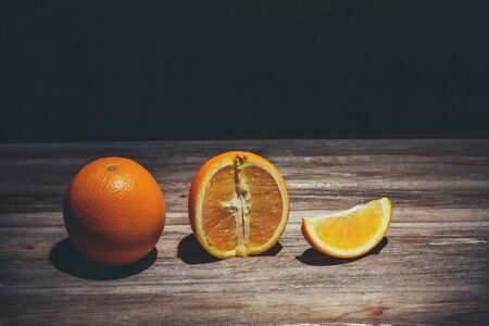 Ripe and tasty orange on a brown wooden surfaceの写真素材