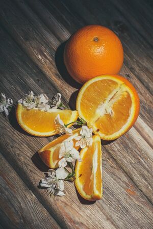 Ripe and tasty orange on a brown wooden surfaceの写真素材