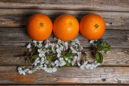 Ripe and tasty orange on a brown wooden surfaceの写真素材