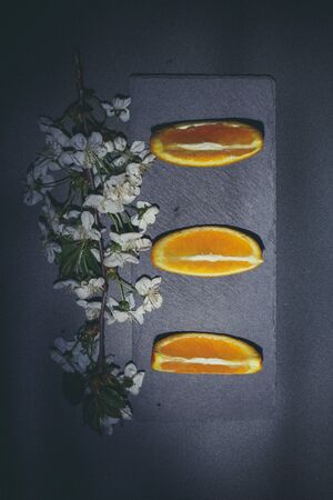 Sweet ripe orange on a black surface and black backgroundの写真素材