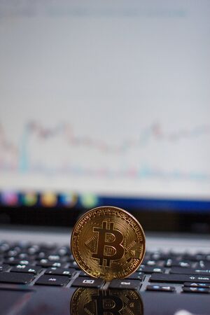 Golden bitcoin on laptop keyboardの写真素材