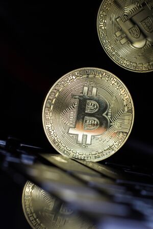 Golden bitcoin on laptop keyboardの写真素材