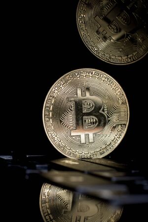 Golden bitcoin on laptop keyboardの写真素材
