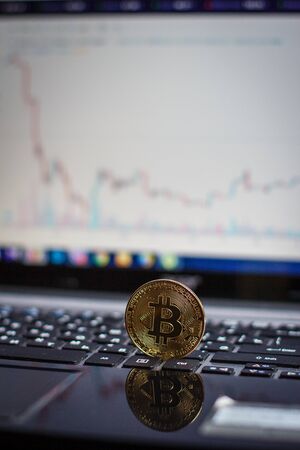 Golden bitcoin on laptop keyboardの写真素材