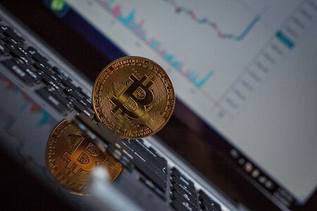 Golden bitcoin on laptop keyboardの写真素材
