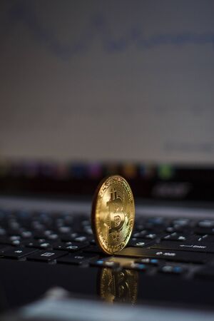 Golden bitcoin on laptop keyboardの写真素材