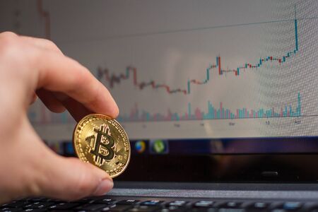 Golden bitcoin on laptop keyboardの写真素材