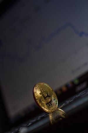 Golden bitcoin on laptop keyboardの写真素材