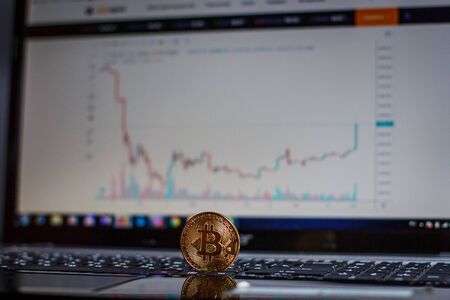 Golden bitcoin on laptop keyboardの写真素材
