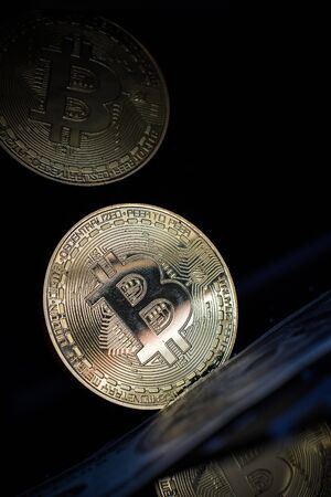 Golden bitcoin on laptop keyboardの写真素材