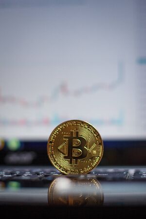 Golden bitcoin on laptop keyboardの写真素材