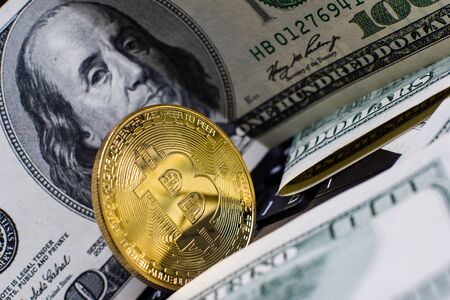 Golden bitcoin and money on laptop keyboardの写真素材