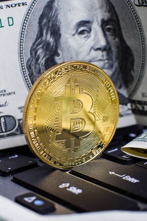 Golden bitcoin on laptop keyboardの写真素材