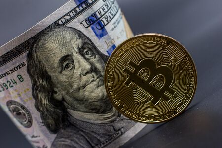 Bitcoin and dollar bill on a black songの写真素材