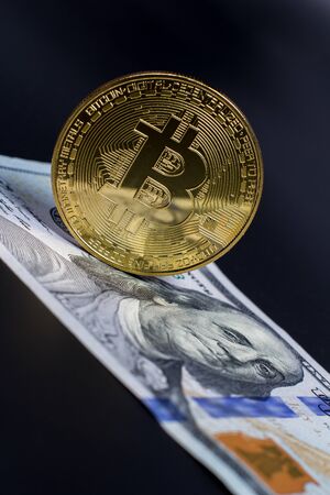 Bitcoin and dollar bill on a black songの写真素材