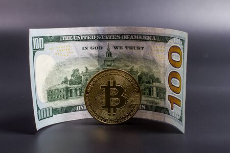 Bitcoin and dollar bill on a black songの写真素材