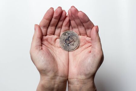 Bitcoin coin in the palmsの写真素材