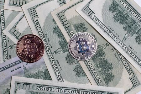 Two bitcoins on a background of money.の写真素材