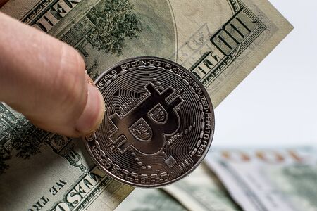 Bitcoin and money hold by hand