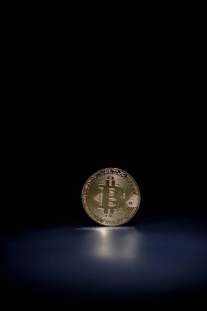 Golden bitcoin on a black backgroundの写真素材