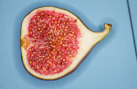 Ripe figs on a blue wooden surfaceの写真素材