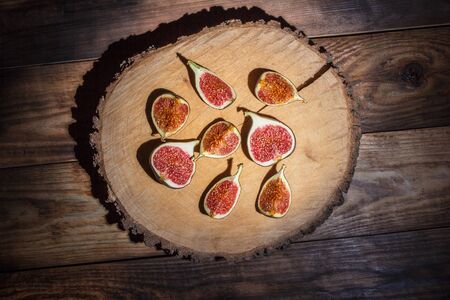 Ripe Sliced Figs on a Wooden Surfaceの写真素材