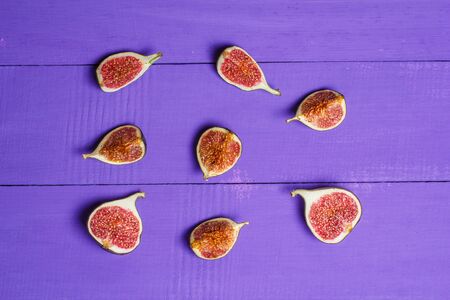 Ripe figs on a blue wooden surfaceの写真素材