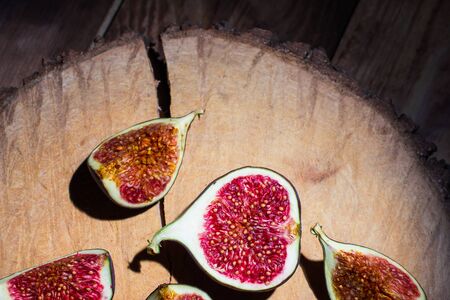 Ripe Sliced Figs on a Wooden Surface