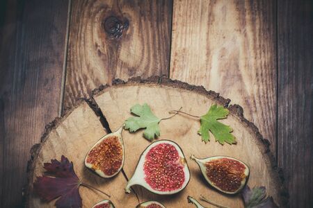 Ripe Sliced Figs on a Wooden Surfaceの写真素材