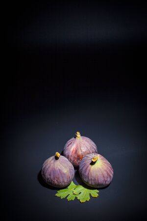 Figs on a black surface and black backgroundの写真素材