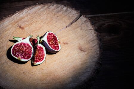 Ripe Sliced Figs on a Wooden Surfaceの写真素材