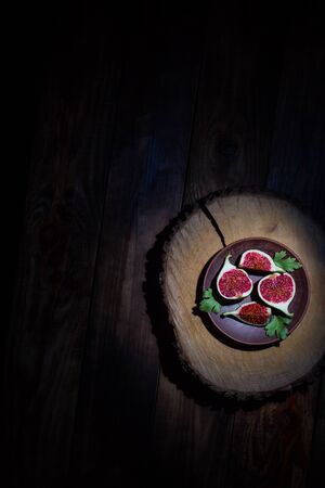 Ripe Sliced Figs on a Wooden Surfaceの写真素材