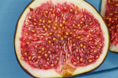 Ripe figs on a blue background closeの写真素材