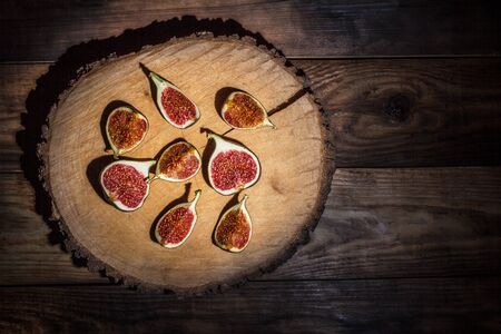 Ripe Sliced Figs on a Wooden Surfaceの写真素材