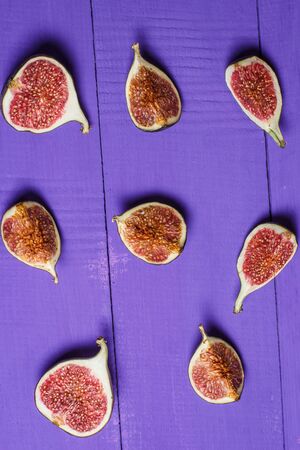 Ripe figs on a purple wooden surfaceの写真素材