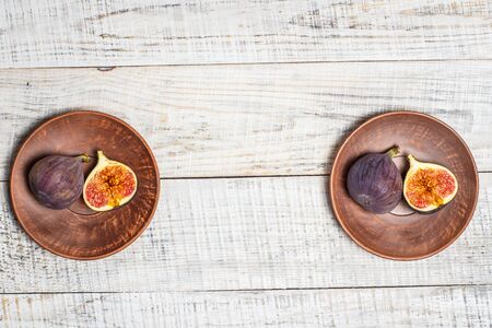 Ripe figs on a white wooden surfaceの写真素材