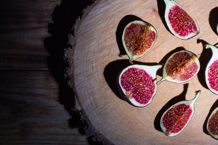 Ripe Sliced Figs on a Wooden Surfaceの写真素材