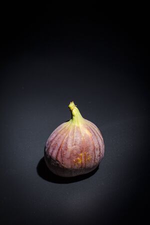 Figs on a black surface and black backgroundの写真素材
