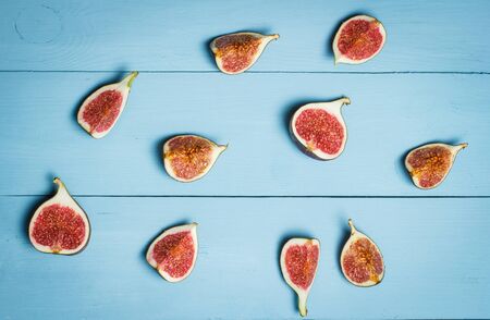 Ripe figs on a blue wooden surfaceの写真素材