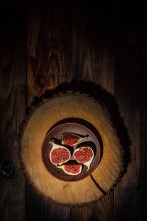 Ripe Sliced Figs on a Wooden Surfaceの写真素材