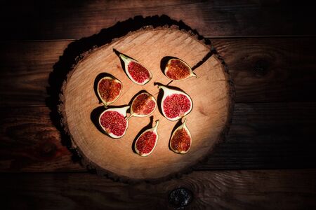 Ripe Sliced Figs on a Wooden Surfaceの写真素材