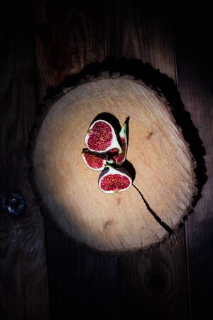 Ripe Sliced Figs on a Wooden Surfaceの写真素材